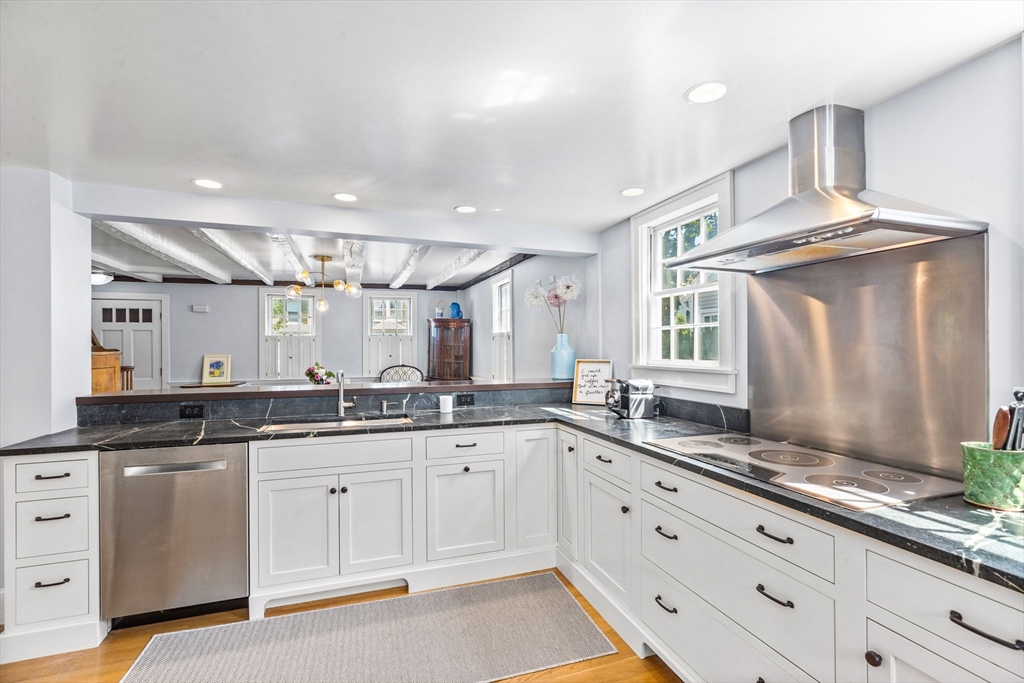 17 Pleasant Street Hingham, MA 02043 - Photo 9 of 41 a large white kitchen with stainless steel appliances granite countertop a sink and cabinets