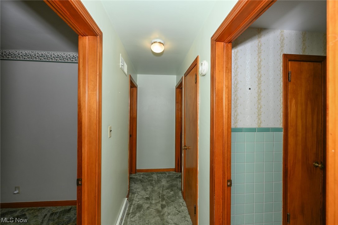 849 Bears Den Road Youngstown, OH 44511 - Photo 15 of 28 Hallway with tile walls and carpet