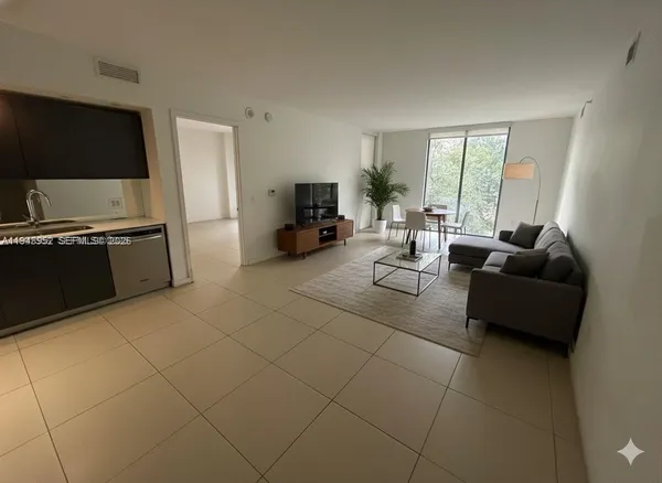 a living room with fireplace furniture and a flat screen tv