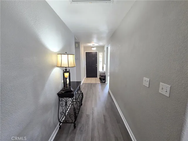 a view of a hallway with wooden floor