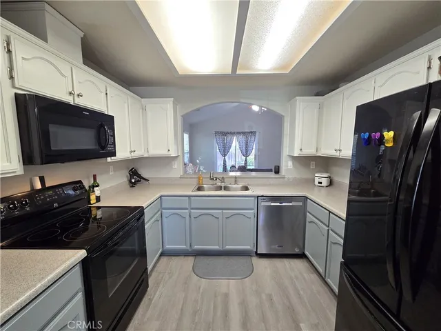 a kitchen with a sink stove and microwave