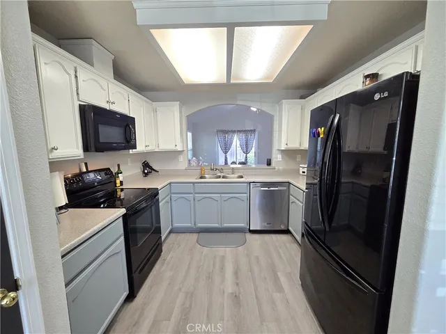 a kitchen with a refrigerator stove and sink