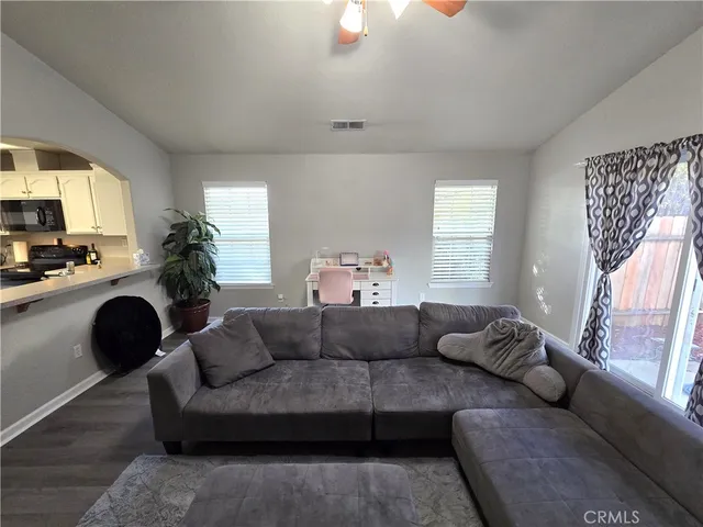 a living room with furniture and a large window