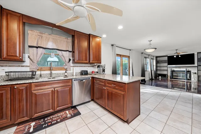 a kitchen with stainless steel appliances granite countertop a stove a sink and a microwave