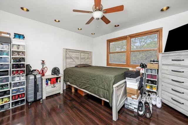 a bedroom with a bed and a flat tv screen