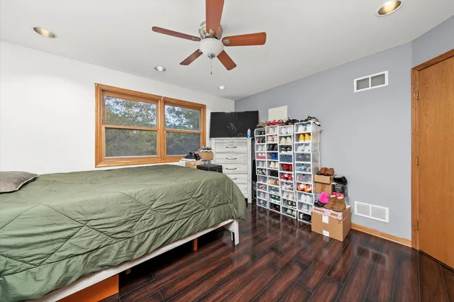 a bedroom with a bed closet and a window