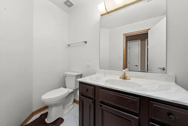 a bathroom with a sink a toilet and mirror
