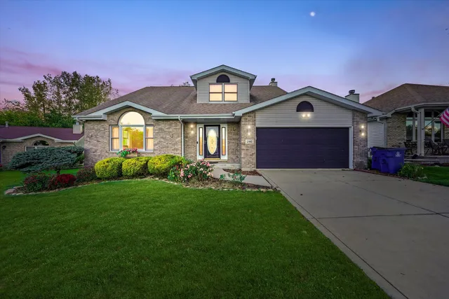 a front view of a house with a yard and garage