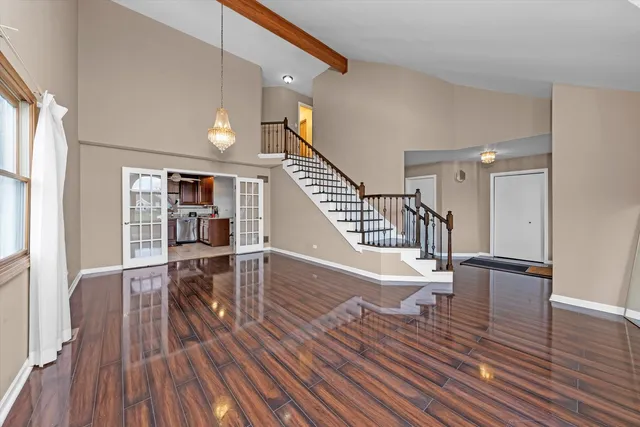 a view of entryway and dining room and wooden floor