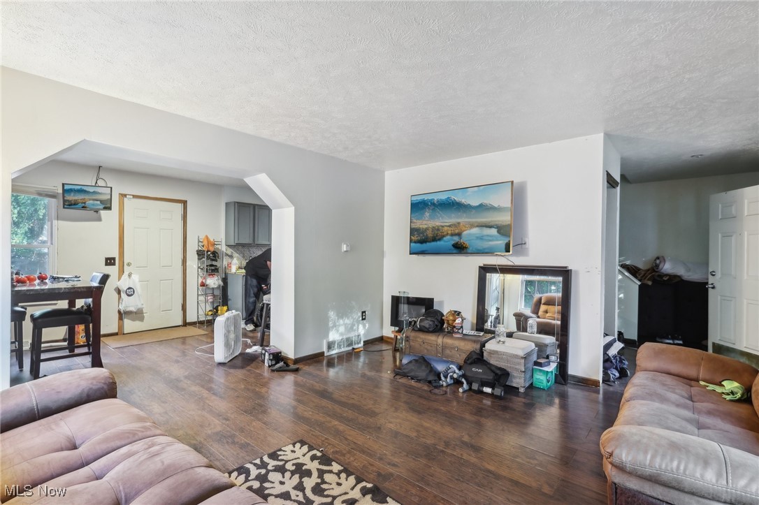 1042 Ansel Road Cleveland, OH 44103 - Photo 11 of 36 Living room featuring a textured ceiling and dark hardwood / wood-style floors