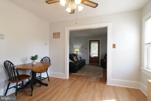 a view of a livingroom with furniture hardwood floor and a window