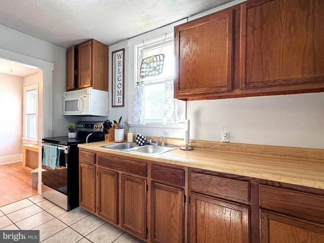 a kitchen with refrigerator and cabinets