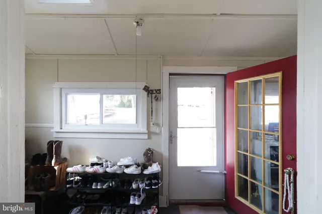 a bedroom with a bed and a flat tv screen on dresser