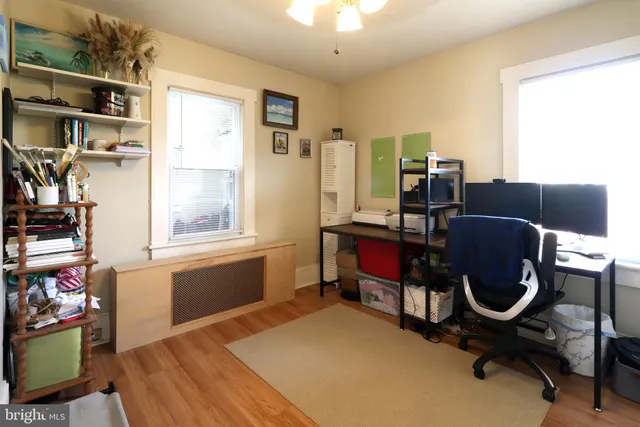 a bedroom with furniture and a wooden floor