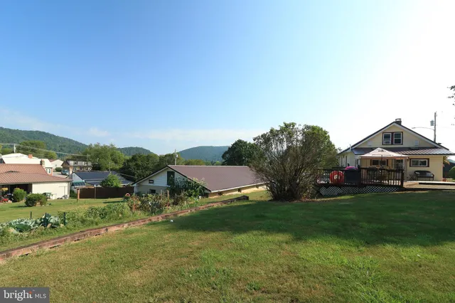 an aerial view of a houses with a street