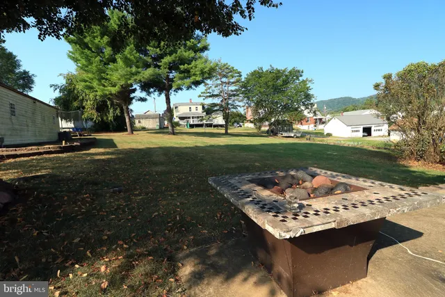 an aerial view of a house with swimming pool and mountains