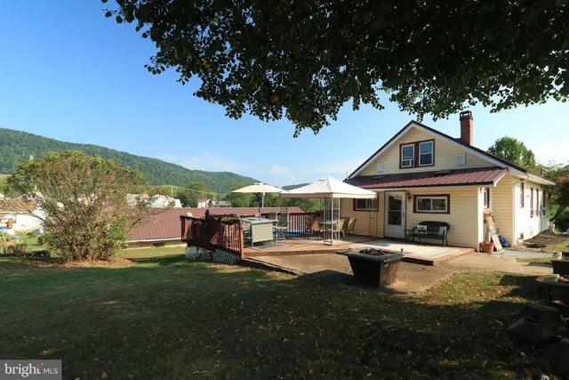 a front view of a house with a yard table and chairs