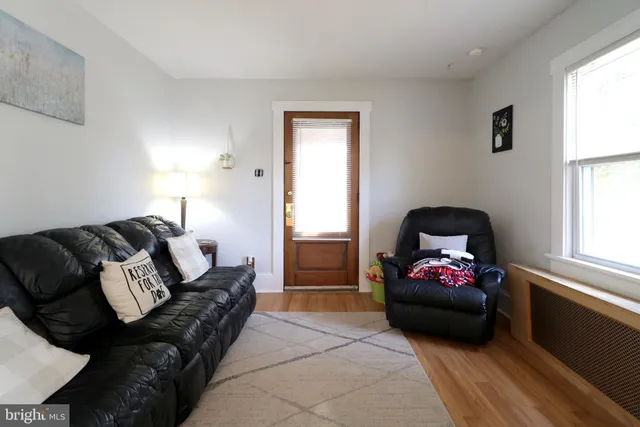a living room with furniture a window and a flat screen tv