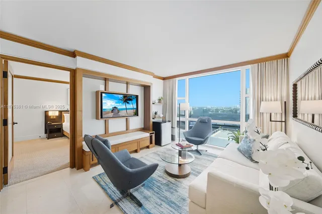 a living room with furniture and a flat screen tv