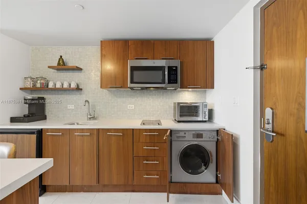 a kitchen with a sink and a stove top oven