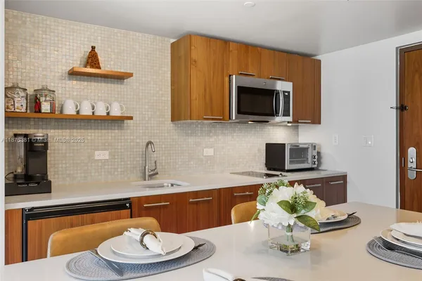 a kitchen with a sink a stove and a dining table