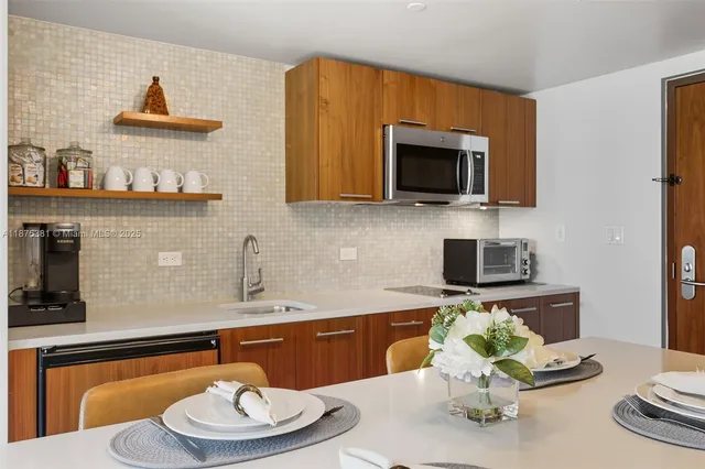 a kitchen with a sink a stove and a dining table