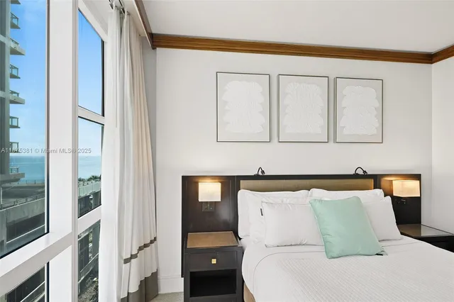 a bedroom with a bed and a mirror