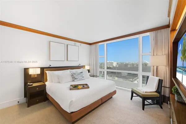 a bed sitting in a room next to a window