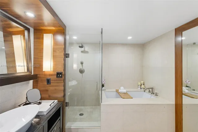 a bathroom with a tub sink toilet and mirror