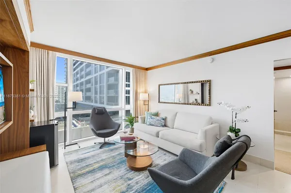 a living room with furniture and a large window