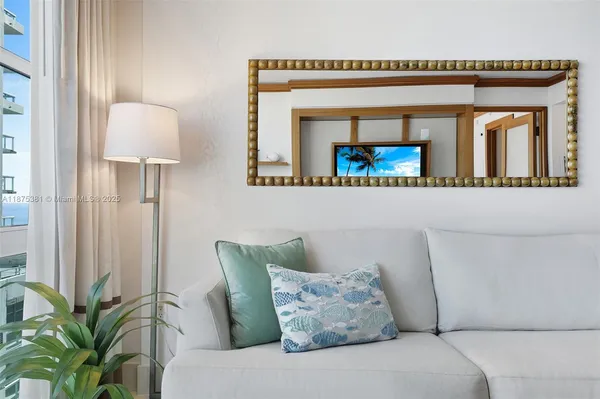 a living room with furniture and a potted plant
