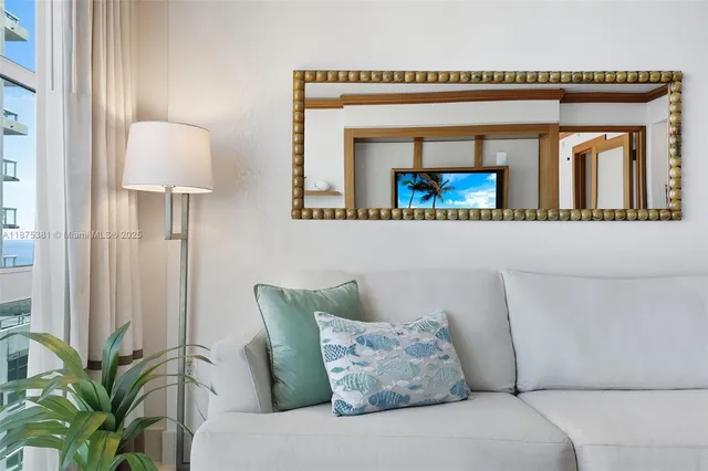 a living room with furniture and a potted plant