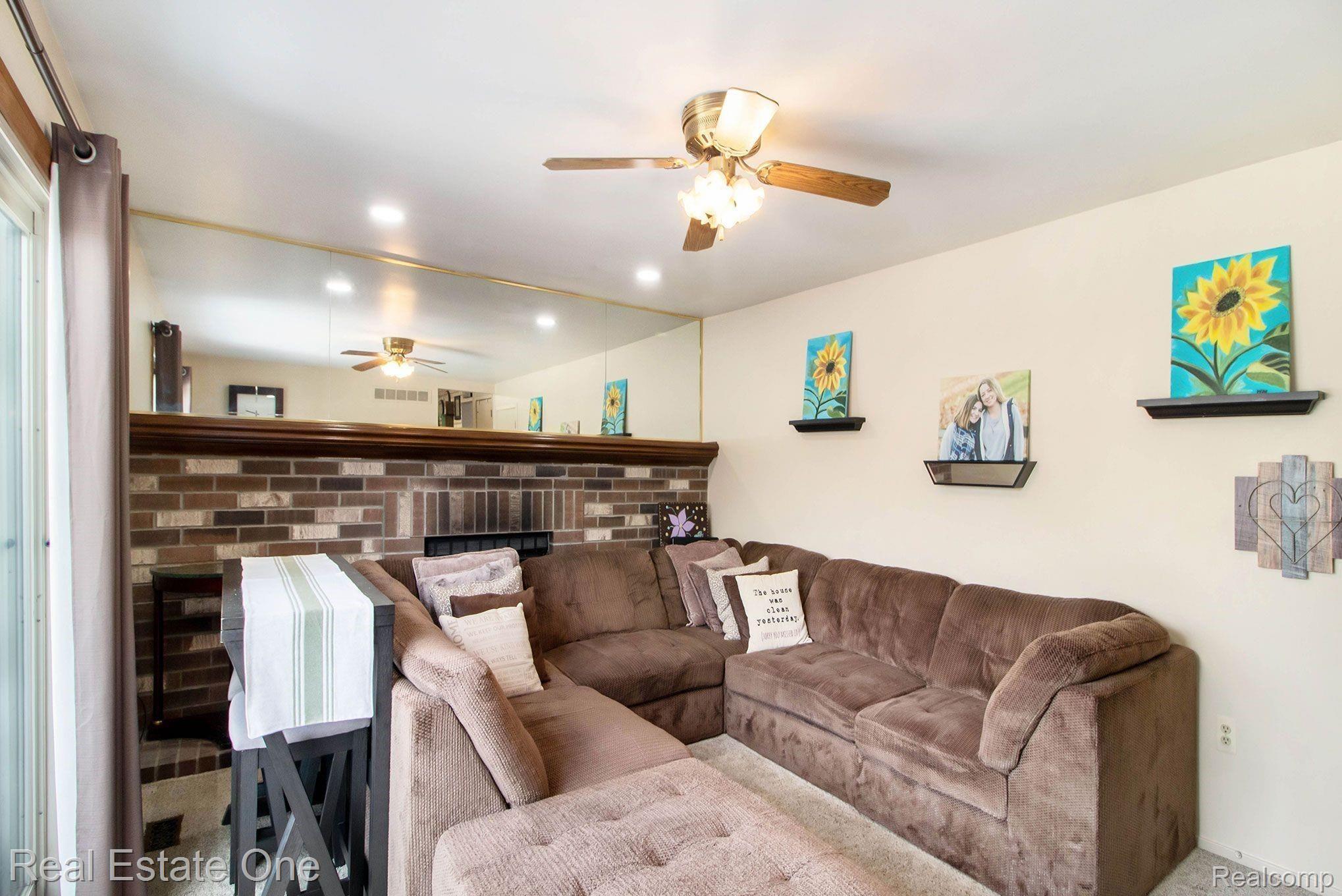 24670 Timber Ridge Trail Flat Rock, MI 48134 - Photo 12 of 39 Family Room With Ceiling Fan & Full length Mirror Over Fireplace Mantle