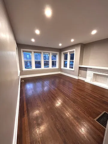 a view of a house with wooden floor and windows