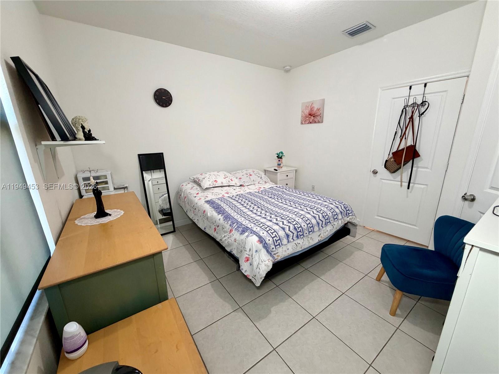 12990 Southwest 232nd Lane Homestead, FL 33032 - Photo 11 of 20 a bedroom with a bed and a couch