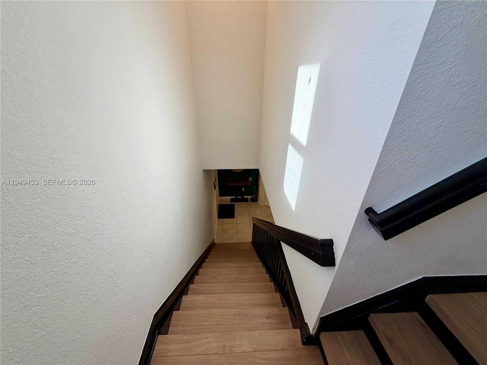 12990 Southwest 232nd Lane Homestead, FL 33032 - Photo 12 of 20 a view of a hallway with wooden floor and staircase