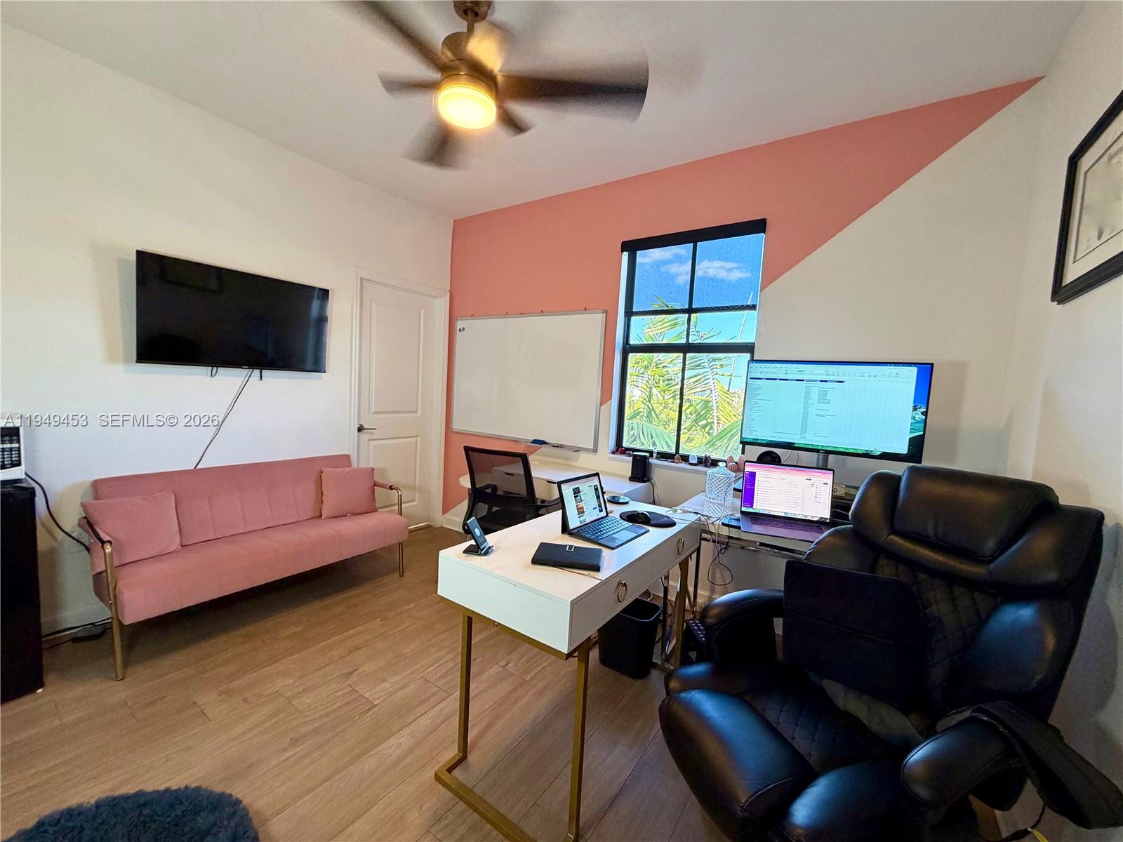12990 Southwest 232nd Lane Homestead, FL 33032 - Photo 16 of 20 a living room with furniture and a flat screen tv