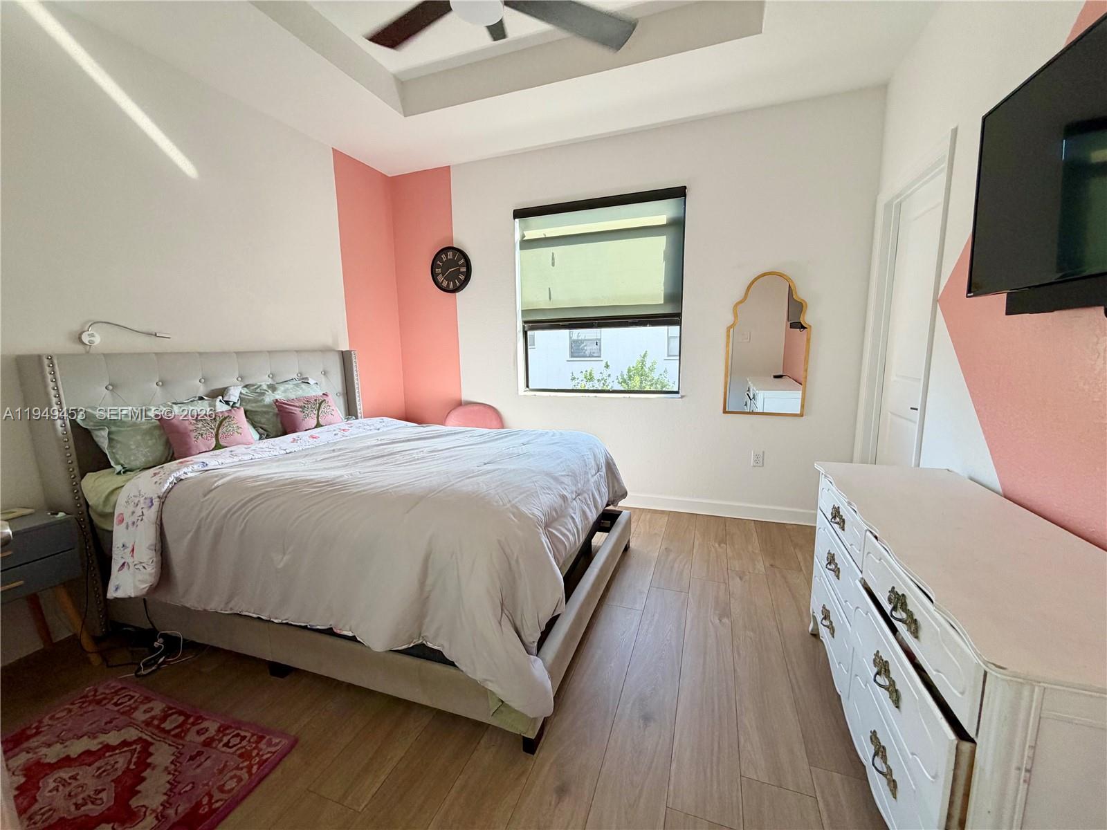 12990 Southwest 232nd Lane Homestead, FL 33032 - Photo 18 of 20 a bedroom with a bed and a flat screen tv