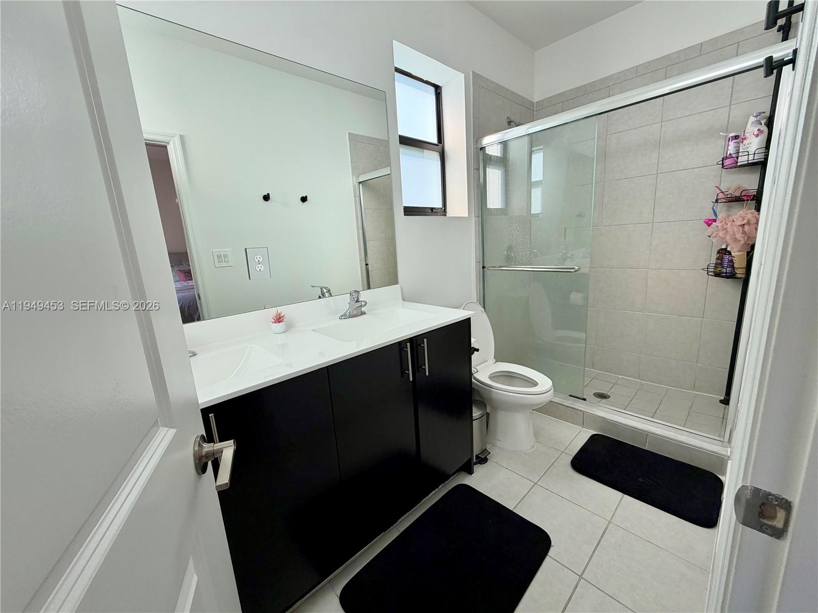 12990 Southwest 232nd Lane Homestead, FL 33032 - Photo 19 of 20 a bathroom with a double vanity sink toilet and shower