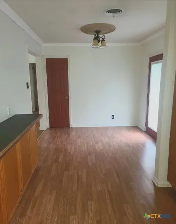 a view of room with wooden floor