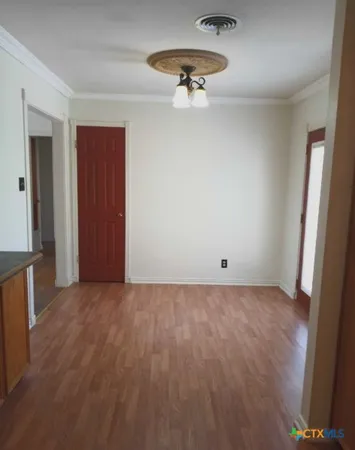 a view of an empty room and a window