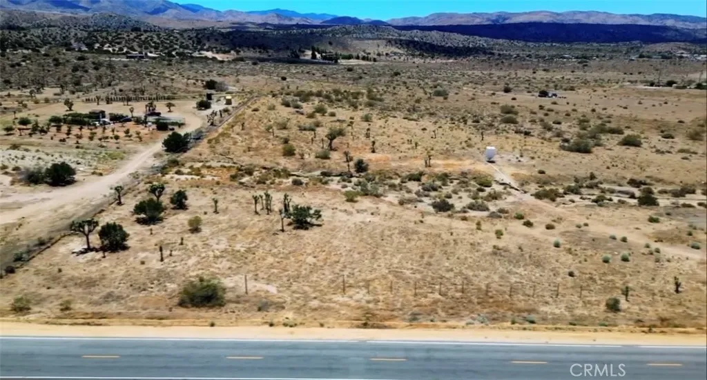 11250 Fort Tejon Road Pearblossom, CA 93553 - Photo 6 of 7 a view of a large yard with wooden floor and fence