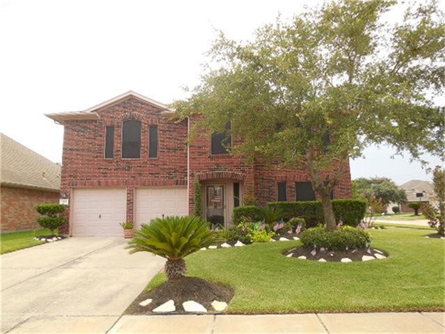 1402 Hunter Ridge Court Fresno, TX 77545 - Photo 1 of 7 a front view of a house with a yard