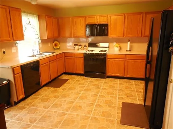 a kitchen with a sink cabinets and window