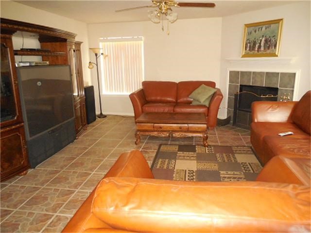 1402 Hunter Ridge Court Fresno, TX 77545 - Photo 4 of 7 a living room with furniture and a fireplace