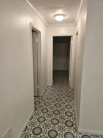 an empty room with a chandelier fan