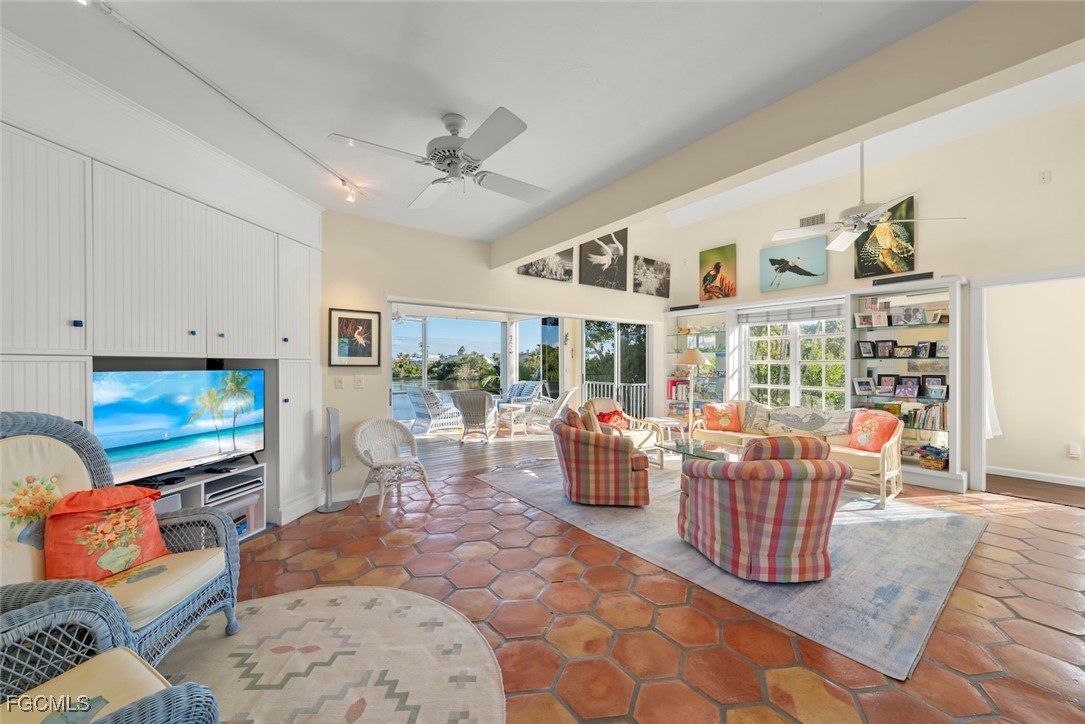 1401 Sand Castle Road Sanibel, FL 33957 - Photo 14 of 50 a living room with fireplace furniture and a flat screen tv