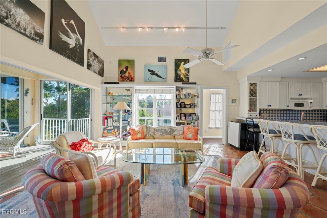 1401 Sand Castle Road Sanibel, FL 33957 - Photo 15 of 50 a living room with furniture kitchen view and large windows