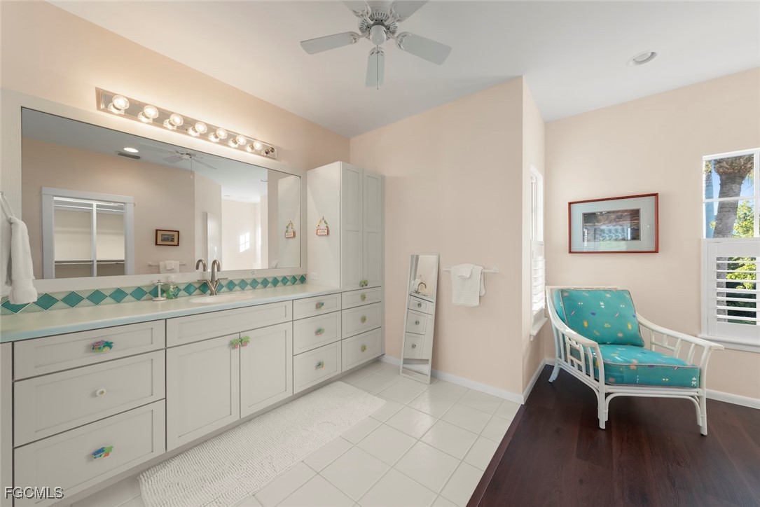 1401 Sand Castle Road Sanibel, FL 33957 - Photo 32 of 50 a spacious bathroom with a granite countertop sink a mirror and a