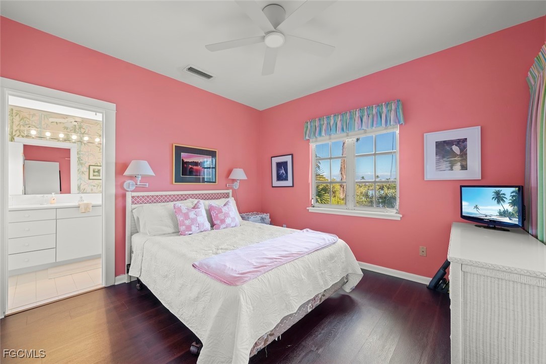 1401 Sand Castle Road Sanibel, FL 33957 - Photo 35 of 50 a bedroom with a bed dresser and a window